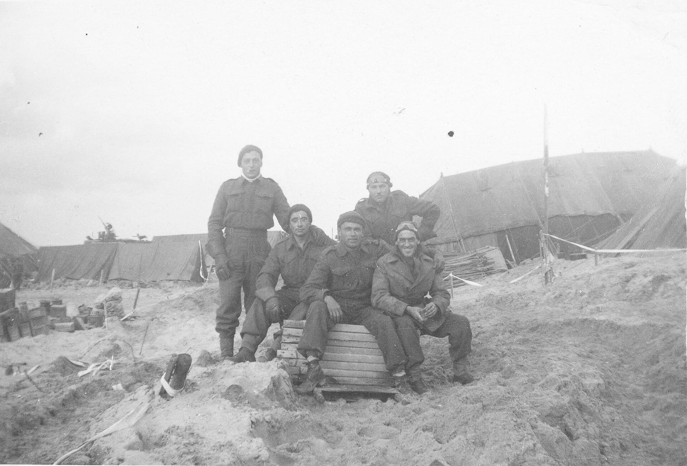 Five Canadian soldiers posing on a beach during the Battle of the Scheldt, 1944